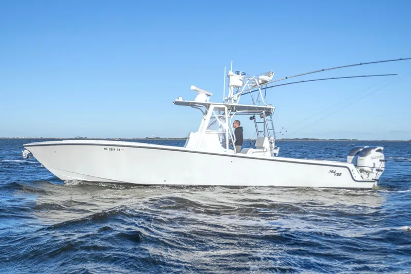  Yacht Photos Pics 2012 SeaVee 340B boat cruising on open water under clear blue sky.