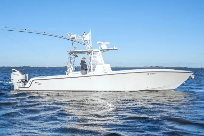  Yacht Photos Pics 2012 SeaVee 340B boat cruising on open water under clear blue sky.