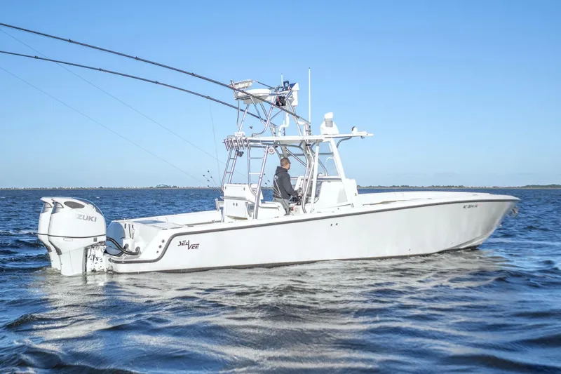  Yacht Photos Pics 2012 SeaVee 340B boat on water, featuring Suzuki outboard engines, clear blue sky.