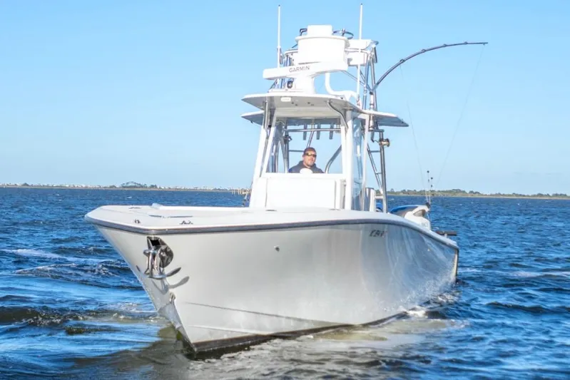  Yacht Photos Pics 2012 SeaVee 340B boat cruising on open water under clear blue sky.