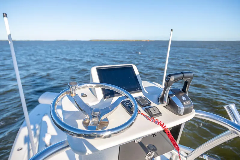 Yacht Photos Pics 2012 SeaVee 340B boat helm with steering wheel and controls on open water.