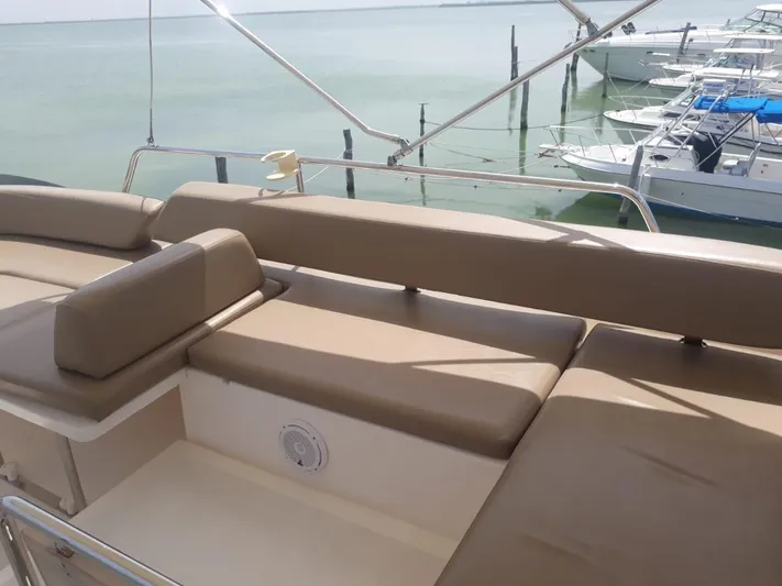 Dreamer Yacht Photos Pics Flybridge seating on 2013 Azimut 40 Flybridge yacht, overlooking calm marina waters.