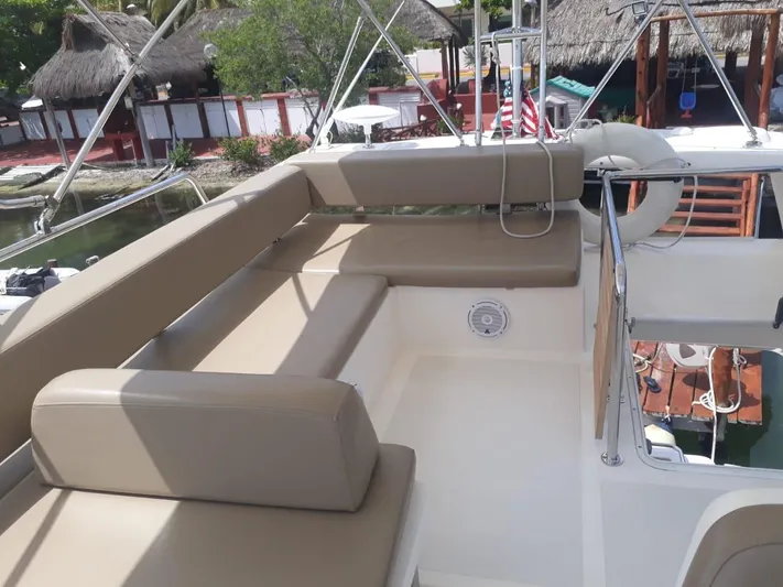 Dreamer Yacht Photos Pics Flybridge seating area on 2013 Azimut 40 Flybridge yacht, featuring beige cushions and scenic marina view.