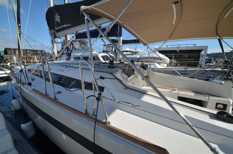 Sea To Summit Yacht Photos Pics 2022 Jeanneau Sun Odyssey 349 sailboat docked at marina, featuring sleek design and spacious deck.