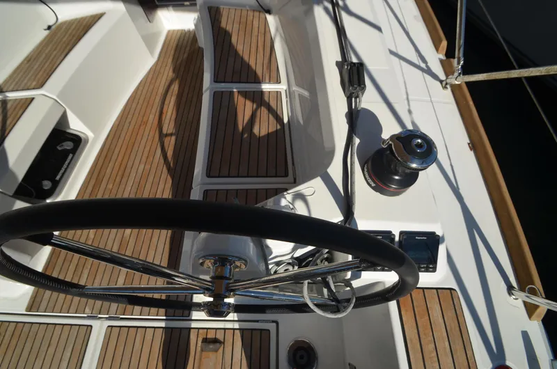 Sea To Summit Yacht Photos Pics Jeanneau Sun Odyssey 349 cockpit, 2022 model, featuring teak decking and steering wheel.