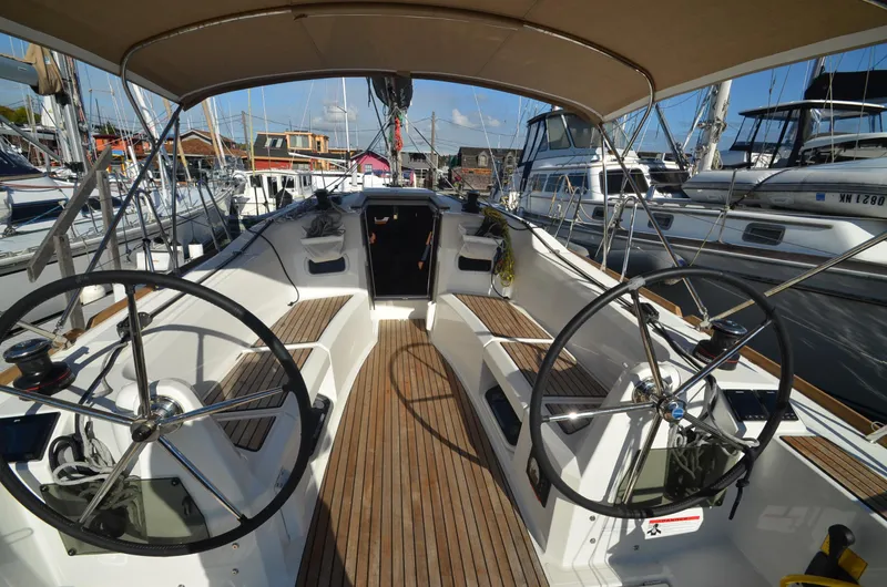 Sea To Summit Yacht Photos Pics 2022 Jeanneau Sun Odyssey 349 sailboat cockpit with dual steering wheels and teak flooring.