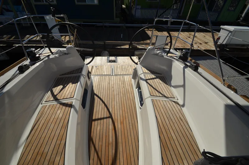 Sea To Summit Yacht Photos Pics 2022 Jeanneau Sun Odyssey 349 sailboat cockpit with dual steering wheels and teak flooring.