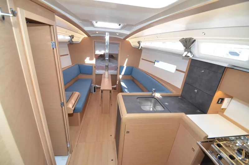 Sea To Summit Yacht Photos Pics Interior of 2022 Jeanneau Sun Odyssey 349 sailboat with modern kitchen and seating area.