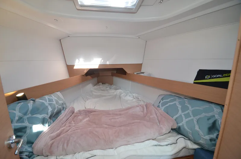 Sea To Summit Yacht Photos Pics Cozy cabin interior of 2022 Jeanneau Sun Odyssey 349 sailboat with bedding.