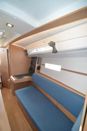 Sea To Summit Yacht Photos Pics Interior of 2022 Jeanneau Sun Odyssey 349 sailboat with blue seating and wooden accents.