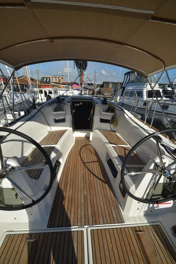 Sea To Summit Yacht Photos Pics 2022 Jeanneau Sun Odyssey 349 sailboat cockpit with dual steering wheels and teak flooring.