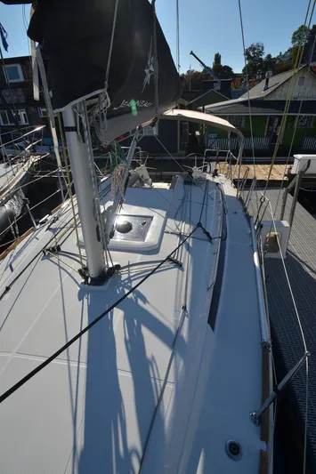 Sea To Summit Yacht Photos Pics 2022 Jeanneau Sun Odyssey 349 sailboat deck view in marina.