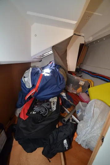 Sea To Summit Yacht Photos Pics Cluttered storage area inside 2022 Jeanneau Sun Odyssey 349 sailboat.
