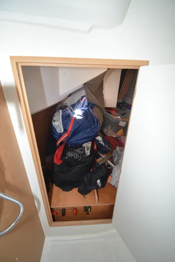 Sea To Summit Yacht Photos Pics Storage compartment in 2022 Jeanneau Sun Odyssey 349 sailboat, filled with gear and equipment.