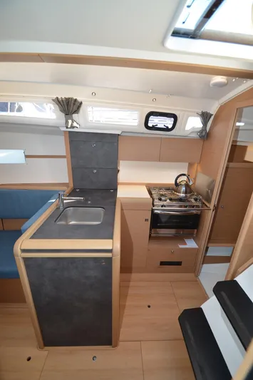 Sea To Summit Yacht Photos Pics Interior of 2022 Jeanneau Sun Odyssey 349 sailboat, featuring modern kitchen and cozy design.