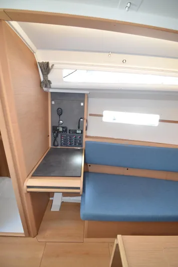Sea To Summit Yacht Photos Pics Interior of 2022 Jeanneau Sun Odyssey 349 sailboat with navigation station and seating area.