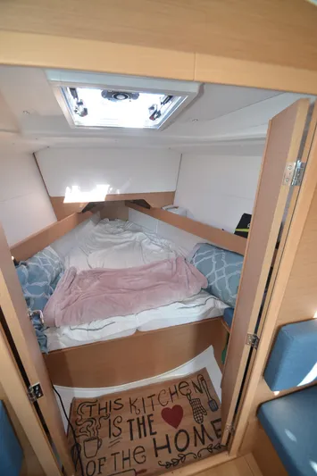 Sea To Summit Yacht Photos Pics Cozy cabin interior of 2022 Jeanneau Sun Odyssey 349 sailboat with bed and decor.