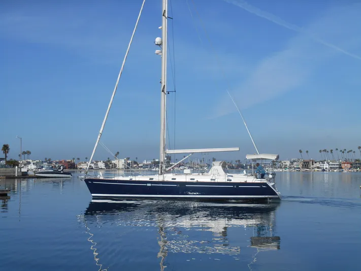 Eventus Yacht Photos Pics Beneteau Oceanis 50 sailboat from 2000 on calm water, clear sky background.