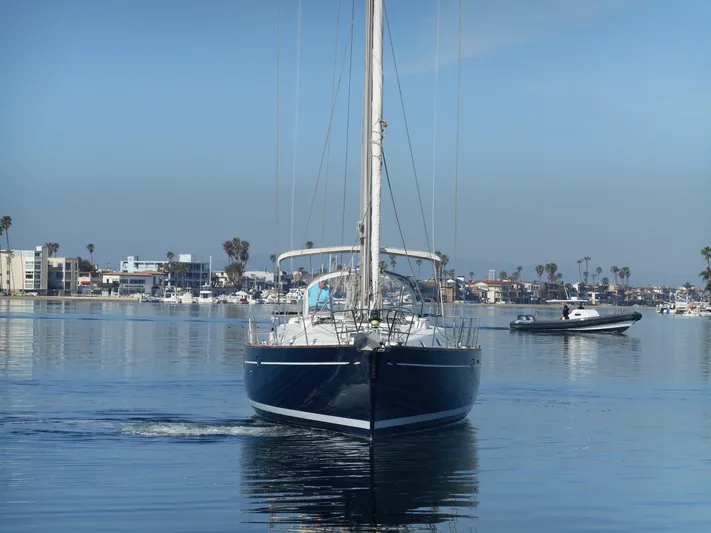 Eventus Yacht Photos Pics Beneteau Oceanis 50 sailboat from 2000 cruising in a calm marina.