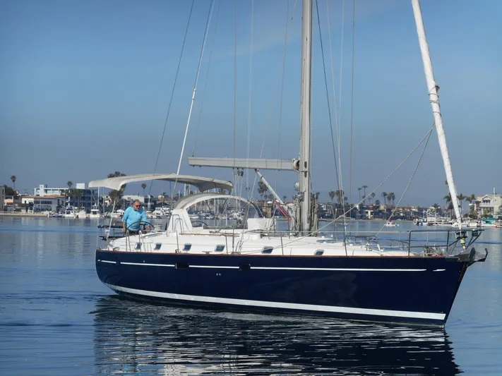 Eventus Yacht Photos Pics 2000 Beneteau Oceanis 50 sailboat cruising in a calm marina setting.