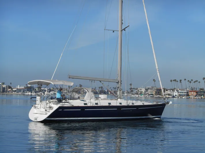 Eventus Yacht Photos Pics Beneteau Oceanis 50 sailboat from 2000 on calm water, clear sky background.