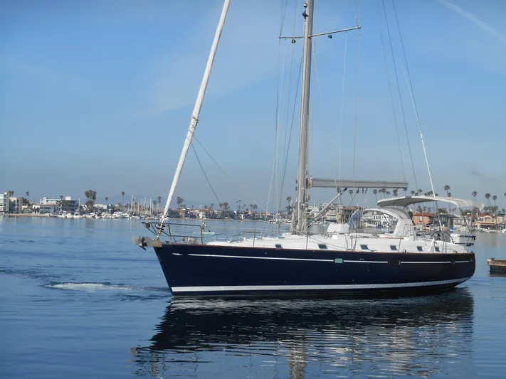 Eventus Yacht Photos Pics Beneteau Oceanis 50 sailboat from 2000 on calm water, clear sky background.
