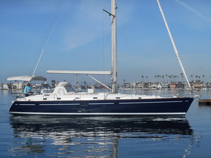 Eventus Yacht Photos Pics 2000 Beneteau Oceanis 50 sailboat on calm water, clear sky background.