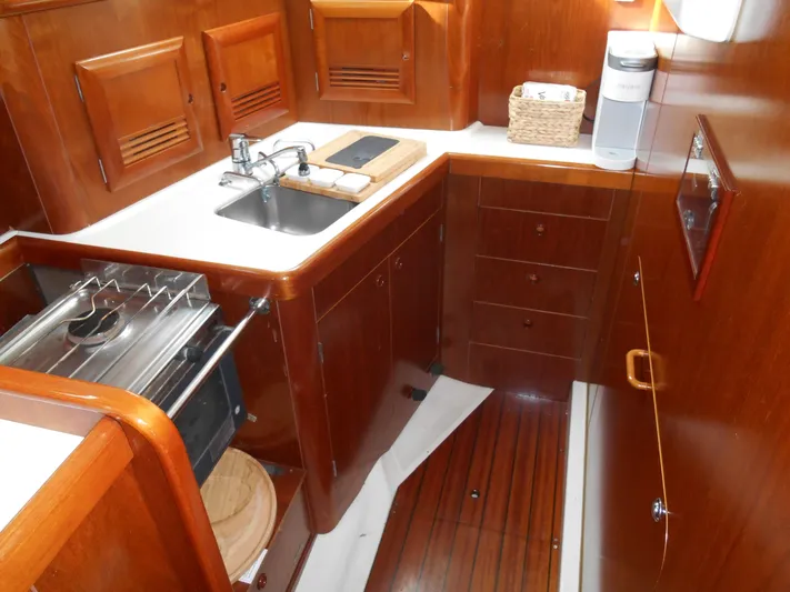 Eventus Yacht Photos Pics Beneteau Oceanis 50 yacht kitchen with wood cabinetry and compact appliances, 2000 model.