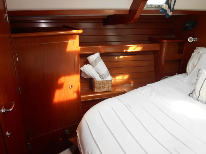Eventus Yacht Photos Pics Cozy cabin interior of 2000 Beneteau Oceanis 50 yacht with wooden paneling and bed.