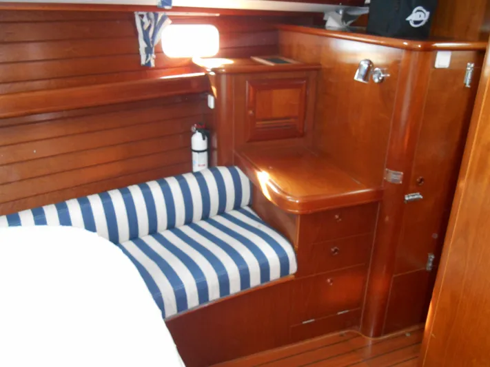 Eventus Yacht Photos Pics Interior of 2000 Beneteau Oceanis 50 yacht with striped seating and wooden cabinetry.