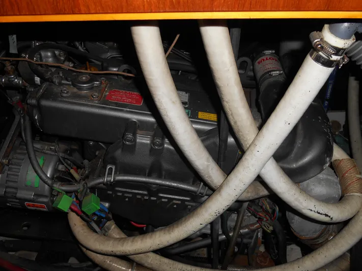 Eventus Yacht Photos Pics Engine compartment of a 2000 Beneteau Oceanis 50 sailboat with visible hoses and components.
