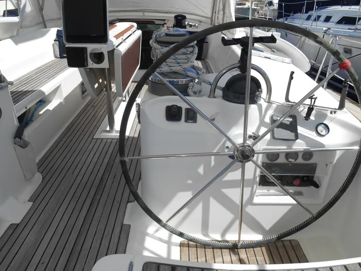 Eventus Yacht Photos Pics Steering wheel of a 2000 Beneteau Oceanis 50 sailboat with wooden deck.