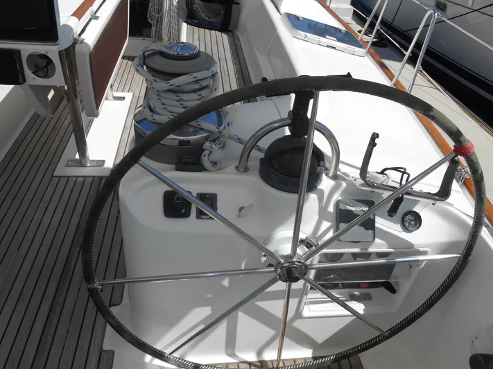 Eventus Yacht Photos Pics Steering wheel of a 2000 Beneteau Oceanis 50 sailboat, featuring deck equipment and controls.