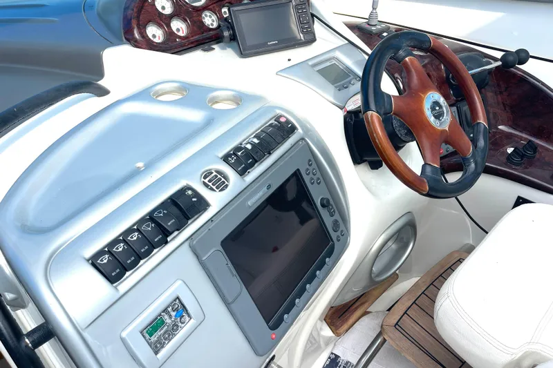 Saphir Bleu Yacht Photos Pics Control panel of 2006 Cranchi Mediterranee 50 HT yacht with steering wheel and navigation instruments.