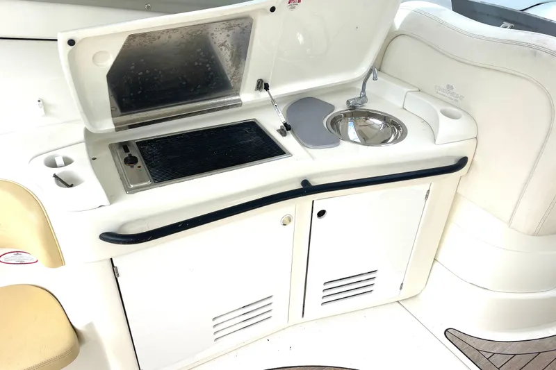Saphir Bleu Yacht Photos Pics Outdoor kitchenette on 2006 Cranchi Mediterranee 50 HT yacht with grill and sink.