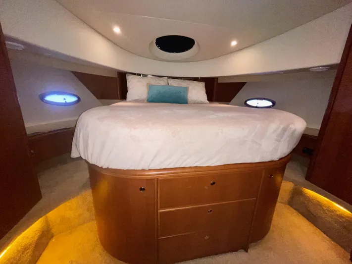 Knot On Call II Yacht Photos Pics Luxurious bedroom in 2006 Silverton 43 Sport Bridge yacht with elegant wood cabinetry.