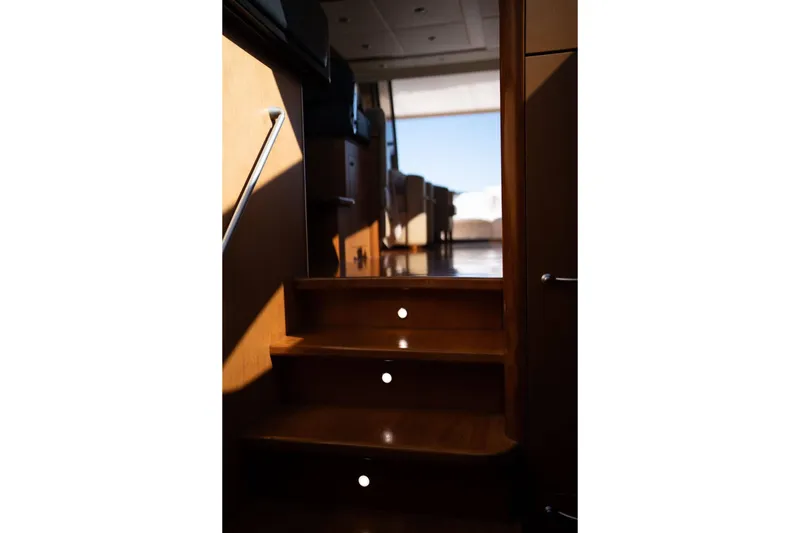  Yacht Photos Pics Interior stairs of 2007 Sunseeker Predator 72 yacht, featuring wooden finish and modern design.