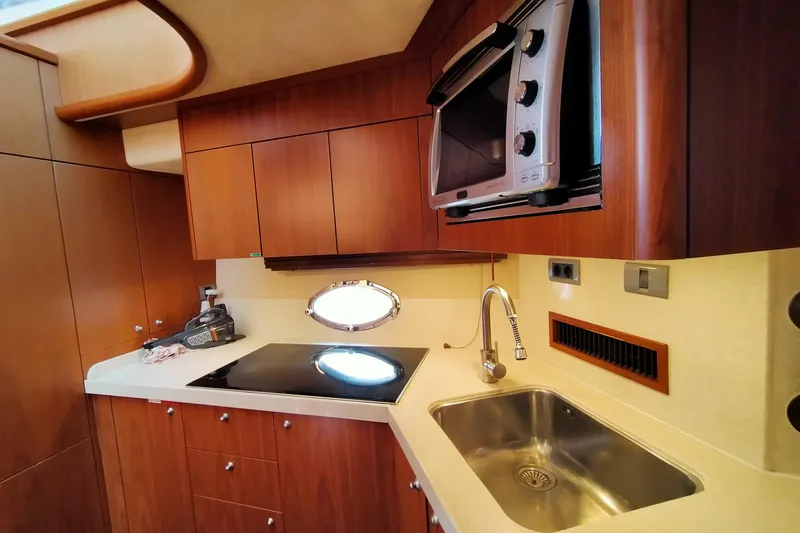  Yacht Photos Pics Luxurious 2007 Sunseeker Predator 72 yacht kitchen with modern appliances and wood cabinetry.