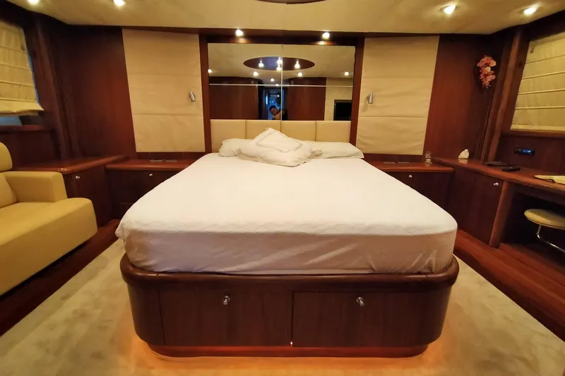  Yacht Photos Pics Luxurious bedroom interior of 2007 Sunseeker Predator 72 yacht with elegant wood finishes.