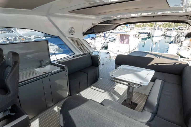  Yacht Photos Pics Luxurious interior of 2018 Azimut Atlantis 51 yacht with modern seating and marina view.