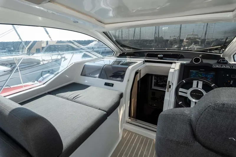  Yacht Photos Pics Interior of 2018 Azimut Atlantis 51 yacht, featuring sleek seating and modern helm controls.
