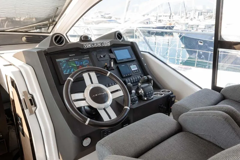  Yacht Photos Pics Helm of 2018 Azimut Atlantis 51 yacht with modern controls and plush seating.