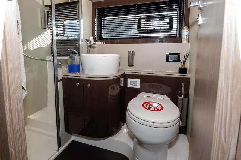  Yacht Photos Pics Luxurious bathroom in 2018 Azimut Atlantis 51 yacht with modern fixtures and sleek design.