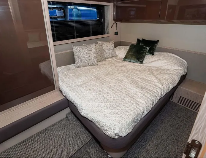  Yacht Photos Pics Luxurious bedroom interior of 2018 Azimut Atlantis 51 yacht with cozy bedding and elegant decor.