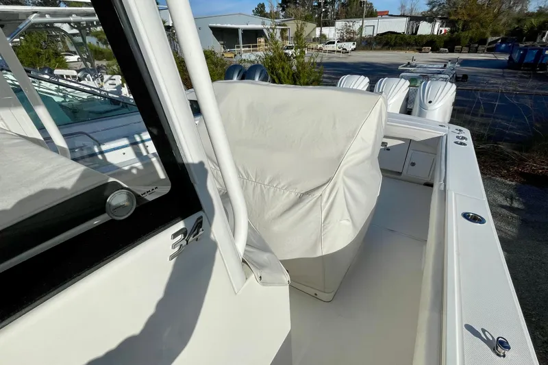  Yacht Photos Pics 2023 Regulator 34 boat with covered seating, docked outdoors.