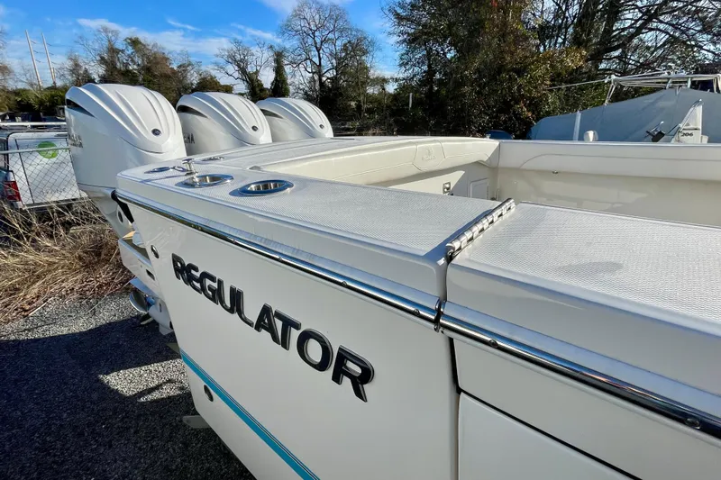  Yacht Photos Pics 2023 Regulator 34 boat with triple engines, sleek design, and spacious deck.