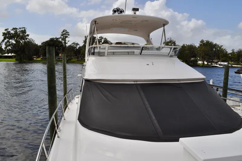 King Leisure Yacht Photos Pics 2002 Sea Ray 480 Sedan Bridge yacht docked by a serene waterfront.