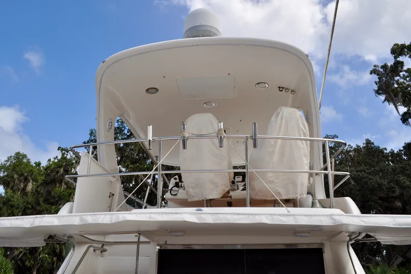 King Leisure Yacht Photos Pics 2002 Sea Ray 480 Sedan Bridge yacht, upper deck view with covered seats, clear sky background.