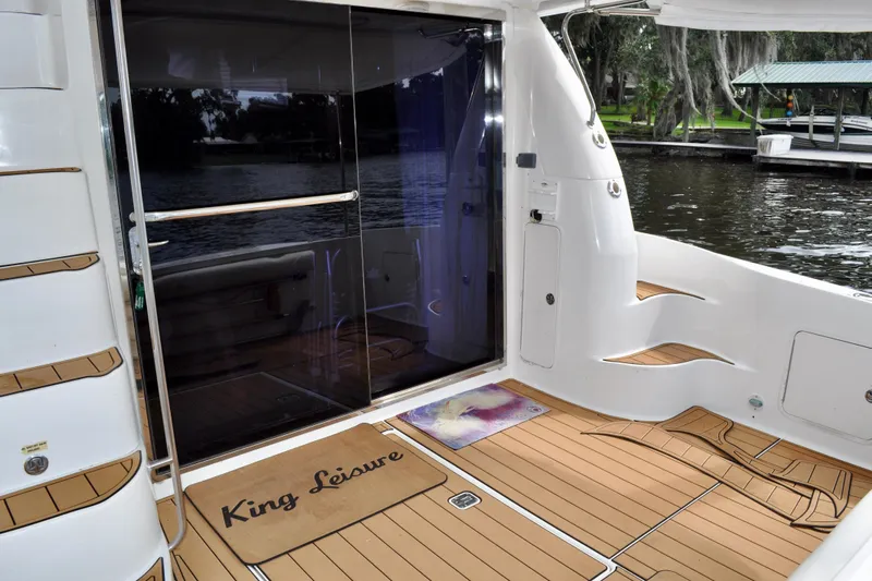 King Leisure Yacht Photos Pics 2002 Sea Ray 480 Sedan Bridge yacht deck with sliding glass door and custom mat.