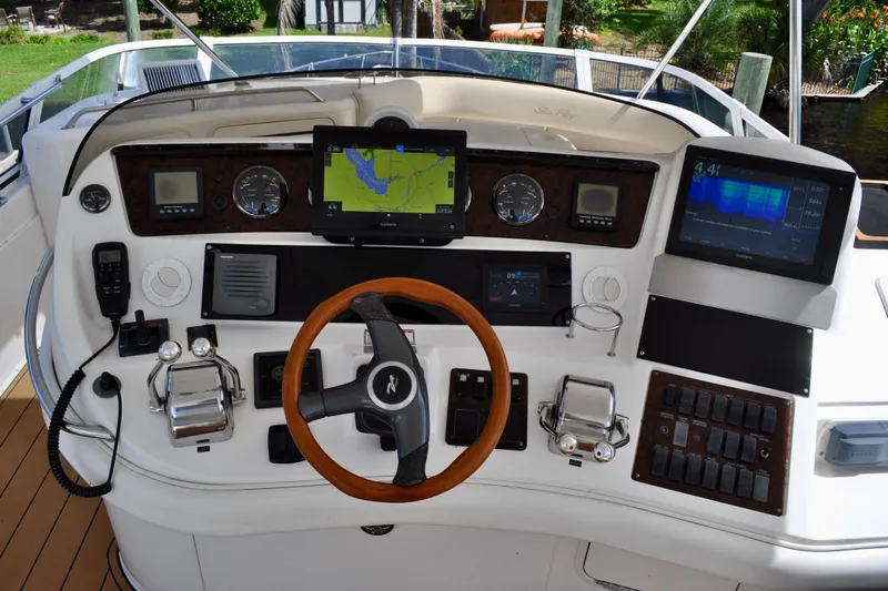 King Leisure Yacht Photos Pics Cockpit of 2002 Sea Ray 480 Sedan Bridge with navigation screens and controls.